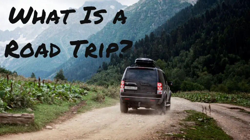 What is a road trip? with an image of a jeep on a dirt road driving away in the mountains.